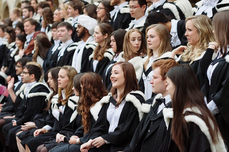Graduation photographs with students in gowns and white fur hoods