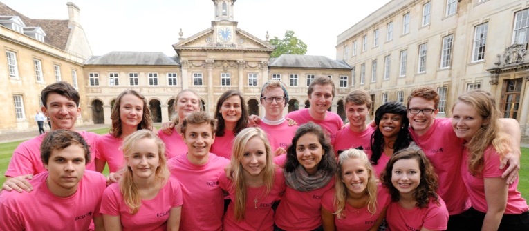 A group of students in pink t-shirts, gathered in Front Court and all smiling at the camera.
