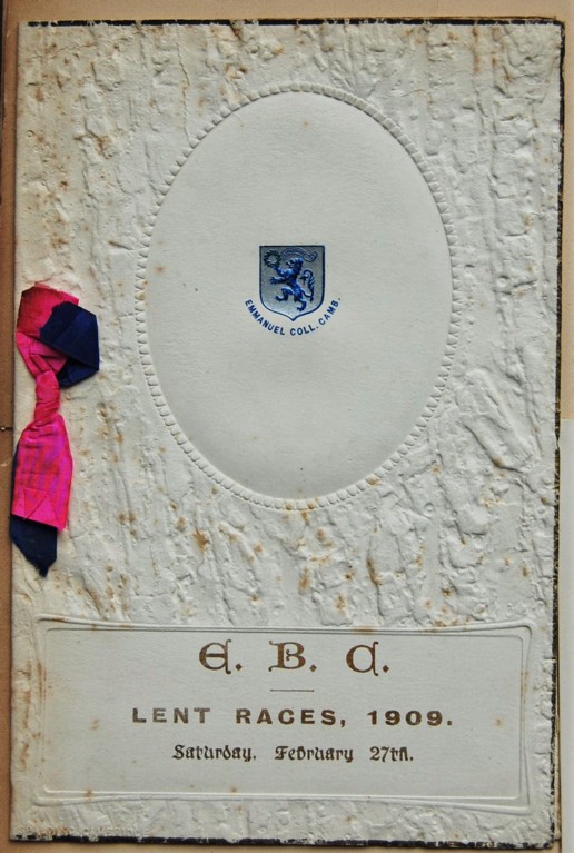 An embossed menu with the college crest in the centre and a pink and blue ribbon attached