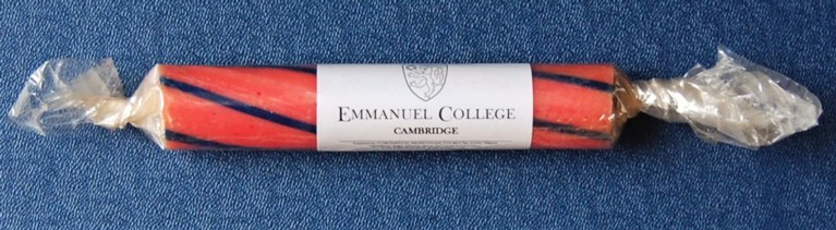A stick of blue and pink rock, branded 'Emmanuel College Cambridge'