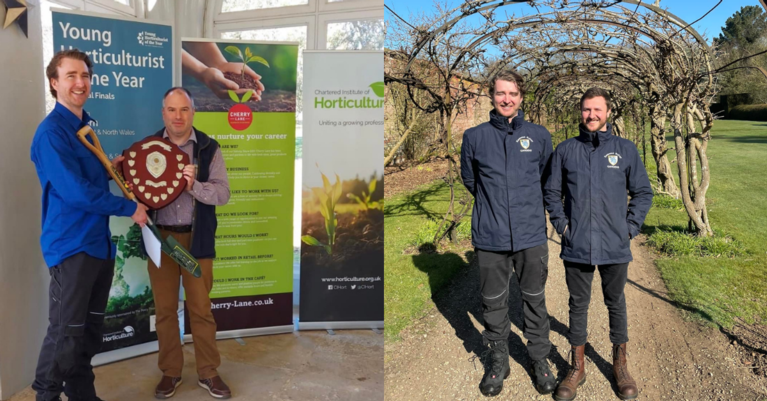 Two men exchanging a shield and spade, and two men dressed in Emmanuel College branded jackets standing in the sun