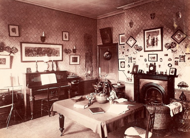 A black and white photo of the inside of a college room