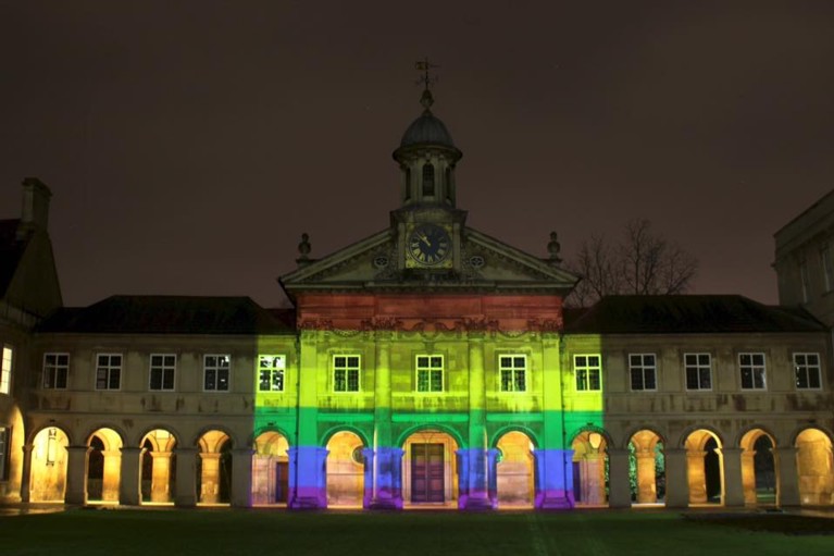 The Pride flag projected onto the College Chapel, during the night