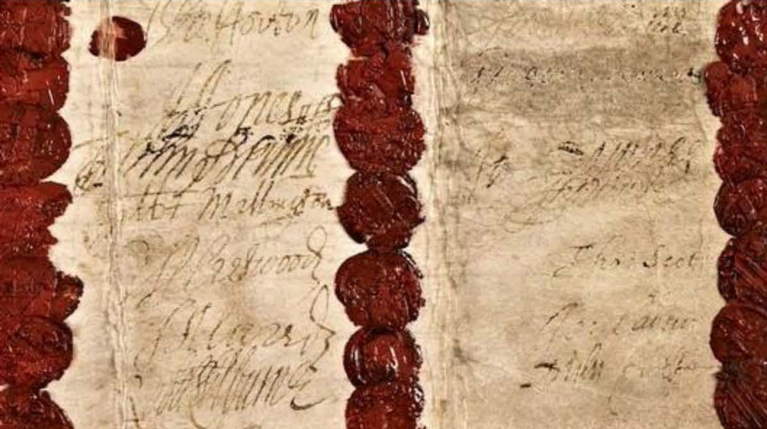 An old warrant for arrest, with many signatures and red wax seals, on beige parchment