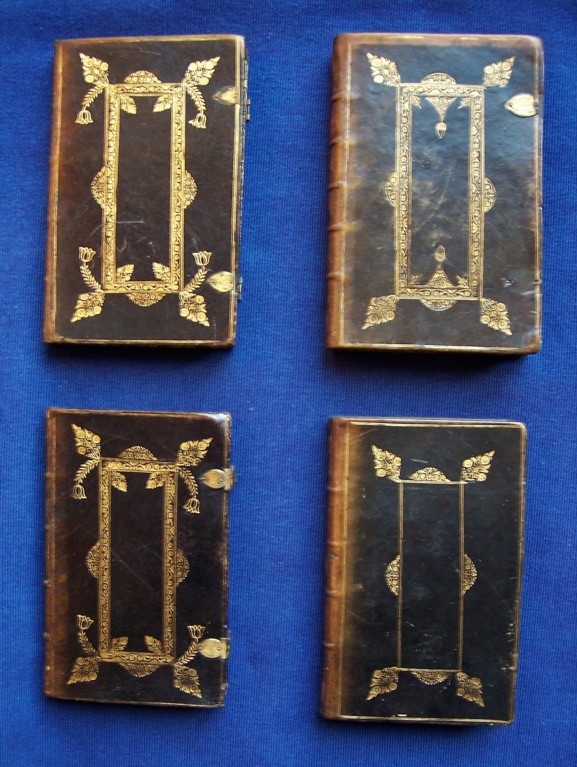 Four books bound in brown and gold