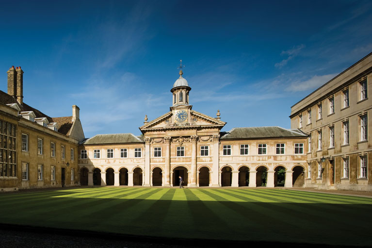 Front Court in the sun with blue skies, from the centre of the Porters' Cloisters